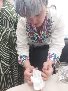 Woman in traditional Ukrainian dress decorating for Orthodox Easter